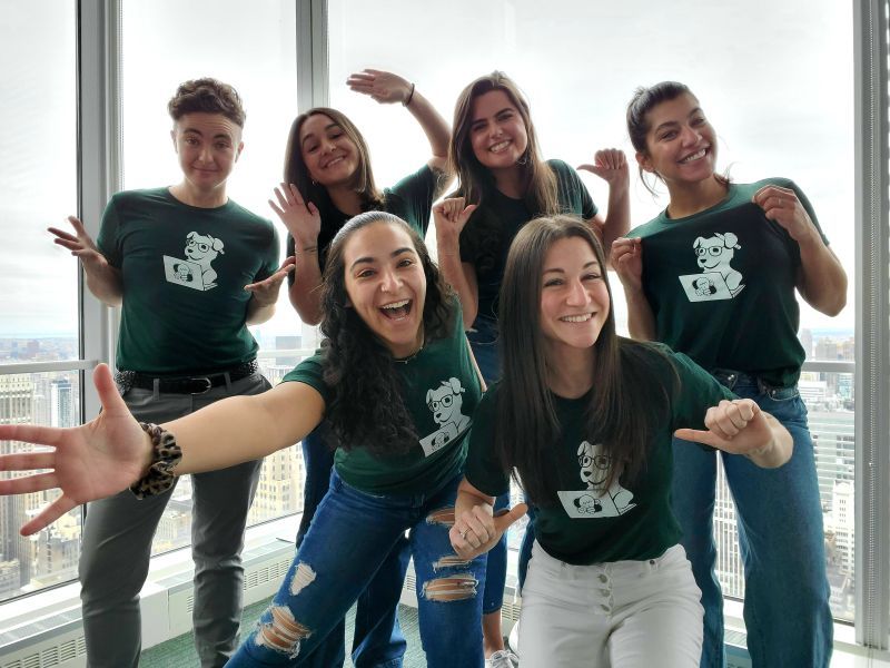 Datadog team members wearing company-branded shirts posing for a photo