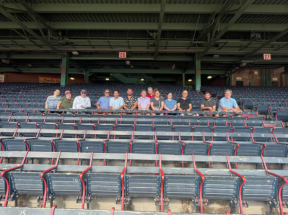 Cohere Team members sit in the stands at Fenway Park.