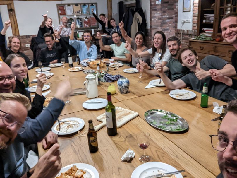 A group of MURAL employees around a dinner table.