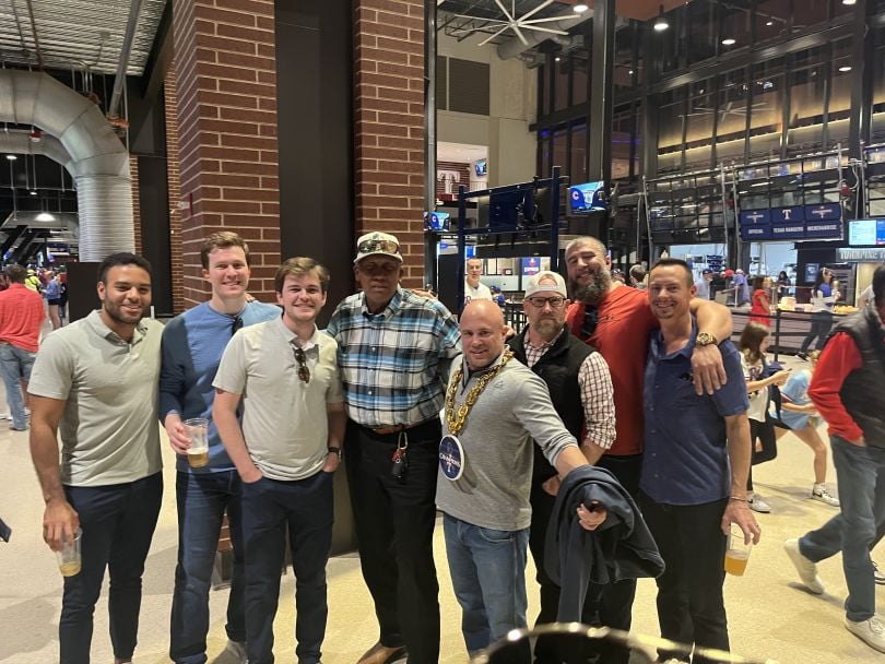 Eastwall team members posing for a photo in a sports stadium.