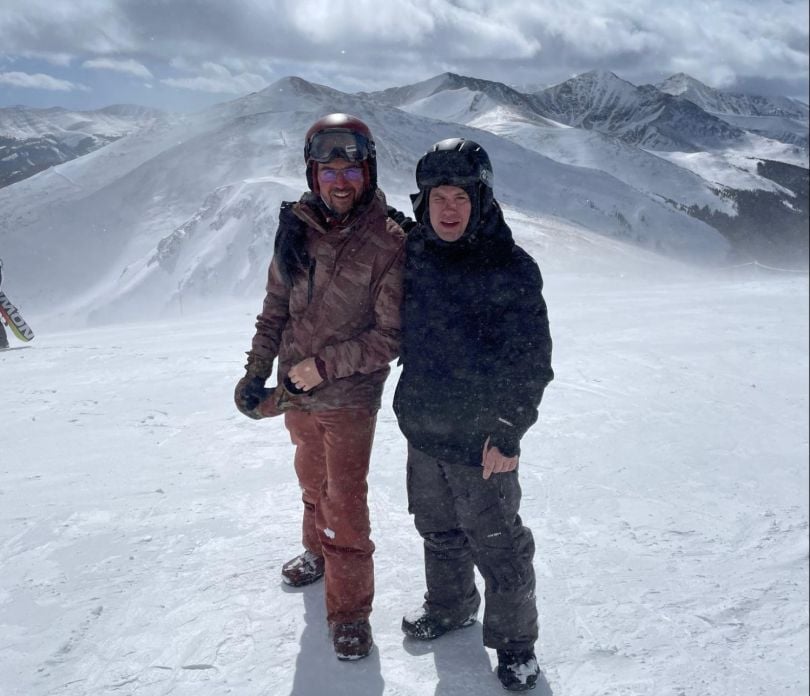 Glenn Mate and Chuck Martin snowboarding on top of a mountain.