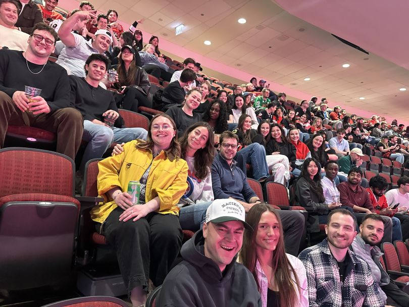Energy CX team members pose for a photo while attending a Chicago Blackhawks hockey game