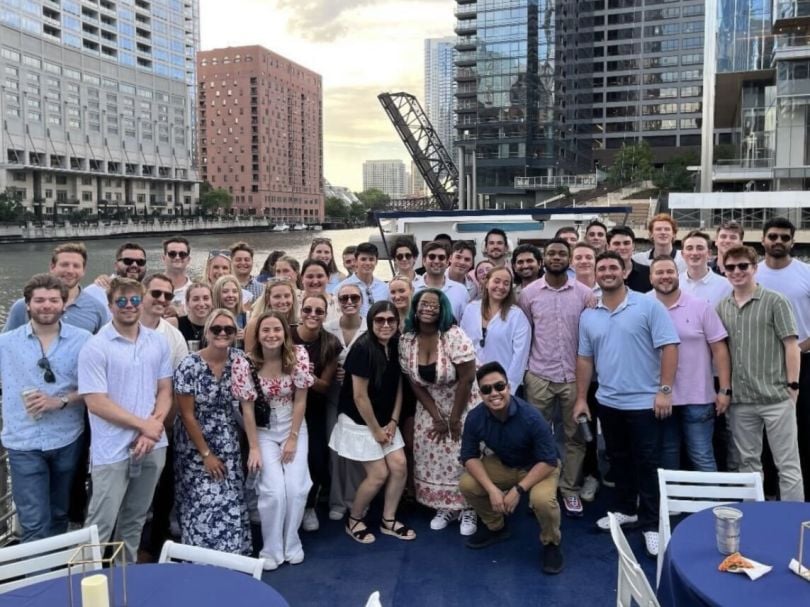 The Energy CX team poses for a group photo near Wolf Point on the Chicago River.