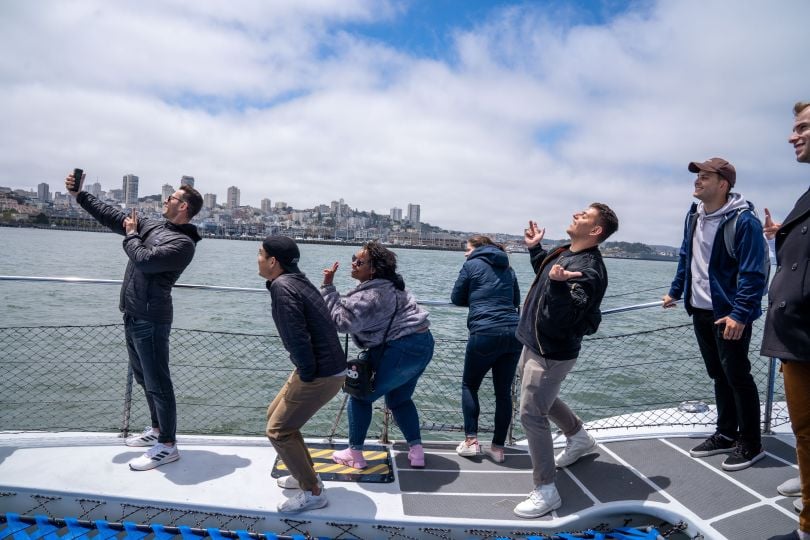 Courier team photo by the water as they get ready for sailing