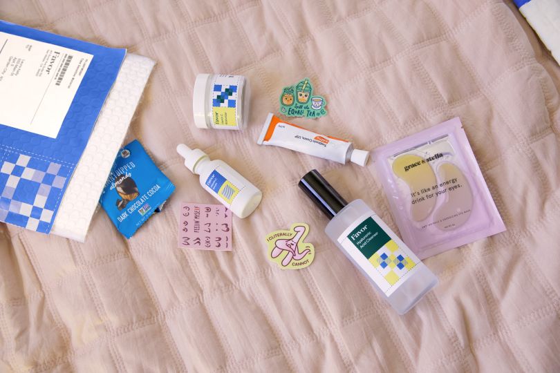 A Favor care package with its contents displayed on a bedspread