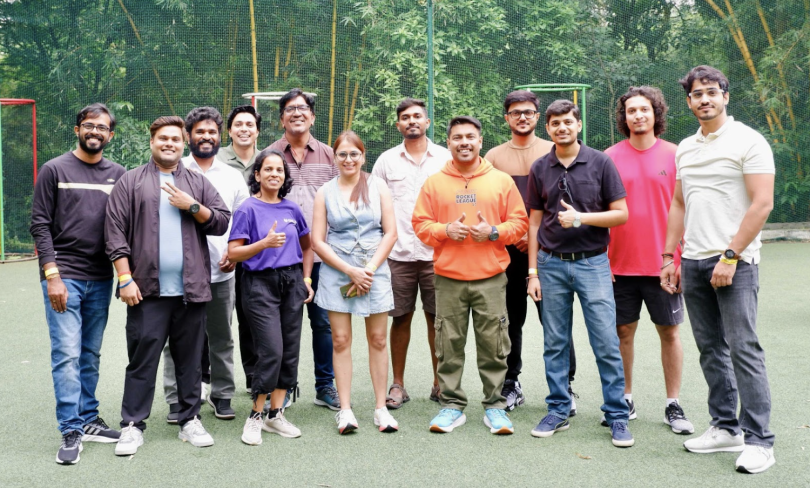 Members of GitLab’s CIO team in India pose for a photo on an outdoor playing field during a team gathering