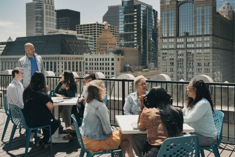 GoHealth employees eating outdoors with the Chicago skyline in the background.