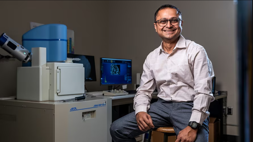 Portrait of Goutam Mohaptra sitting at his desk.