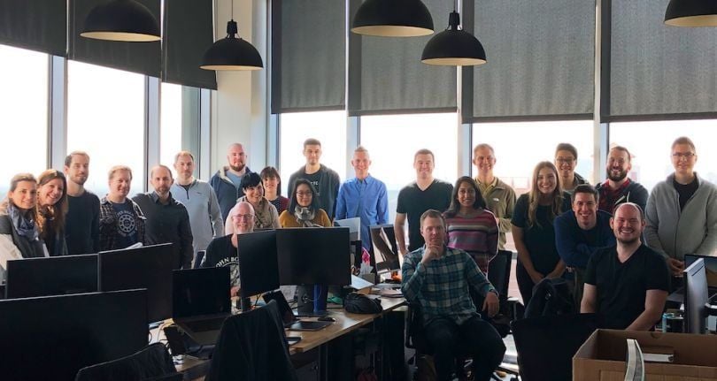 A group of H-E-B employees together in the office.