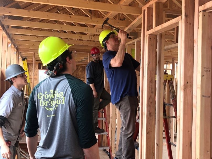 Green Thumb team members working with Habitat for Humanity at a construction site.