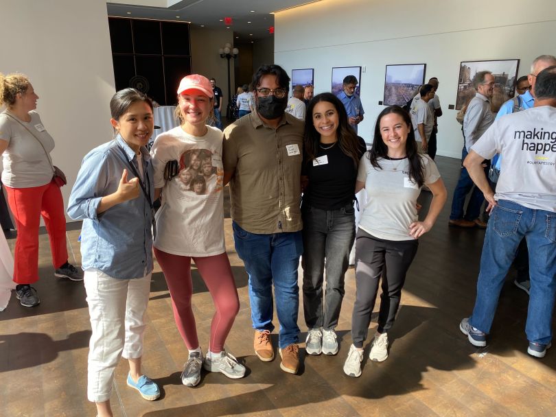 Photo of Lexie Ye standing with colleagues. 