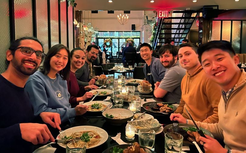 Photo of eight team members out to dinner, seated around a table