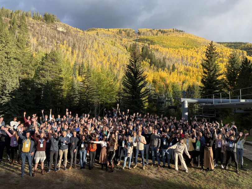 OTA Insight team gathered at the foot of a mountain in Vail