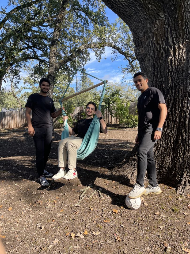 A Nash employee in a sling swing with two colleagues standing nearby