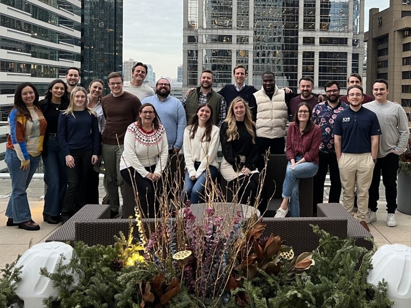 A group of ADM employees pose for a photo on a Chicago rooftop.