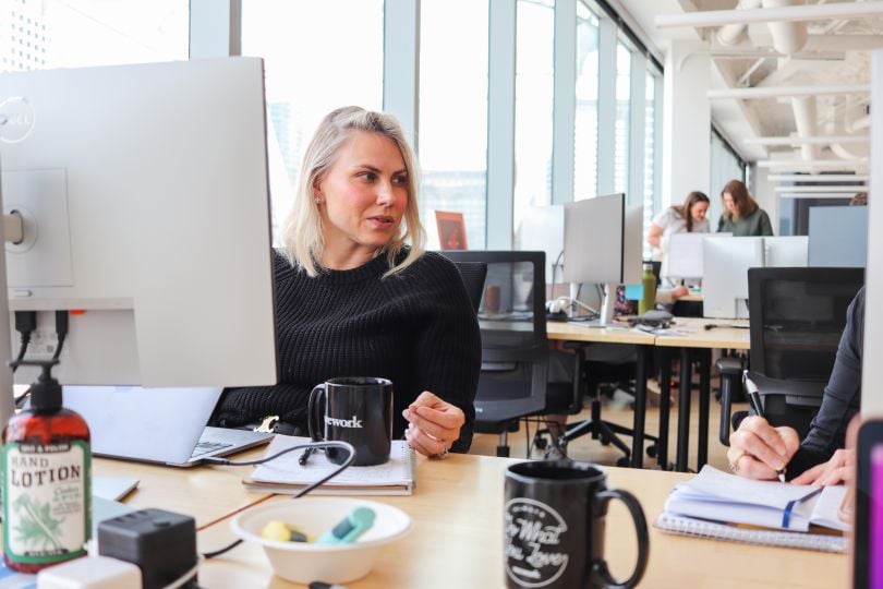 Photo of Kalderos team member at desk talking