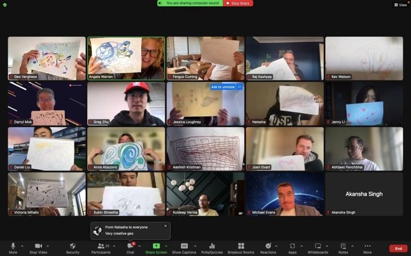 A virtual call with 20 Pluralsight team members holding up drawings.