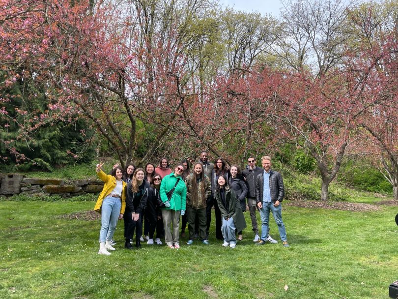 group photo in a grove with red leaf trees