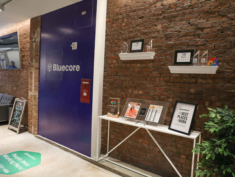 Inside of Bluecore office with company logo on the wall