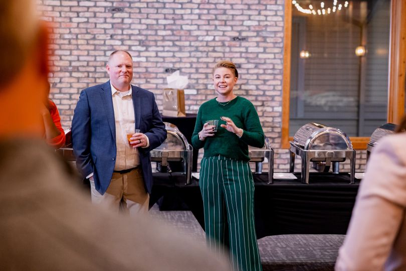 two employees addressing the group