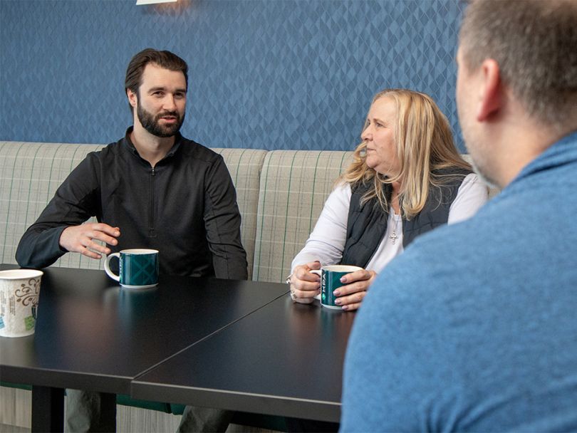 KPA employees discuss a project during a meeting.