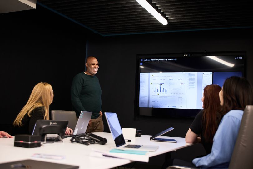 A Kensho employee presents information during a meeting with several colleagues in the company’s office