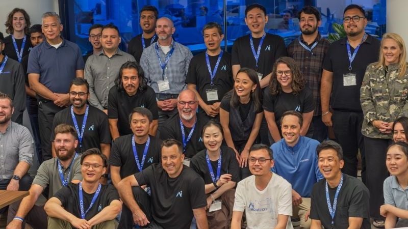 Lessen employees pose together for a group photo. 