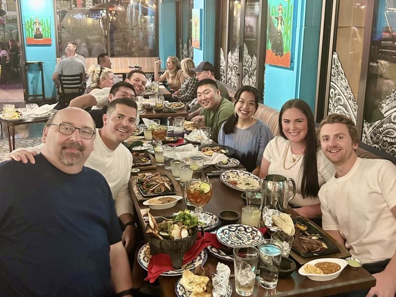 Lob team members at a restaurant, sitting around a table of food.