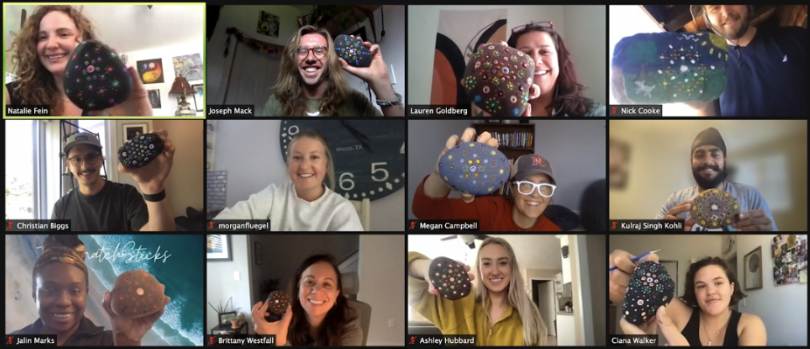 Screenshot of Zoom call with employees holding a painted Mandala rock