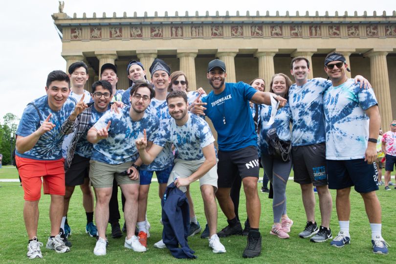 Messari team members pose in blue tie dye t shirts