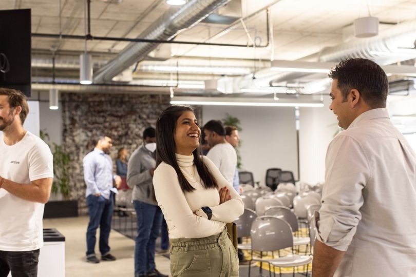 Two Motive team members smiling and laughing while having a conversation