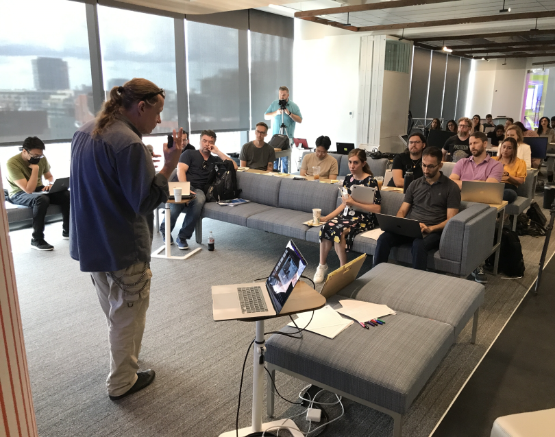 Photo of Randy Simms presenting in front of the CCC team. 