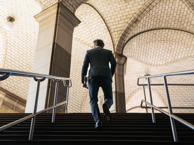 Businessman walking up flight of stairs