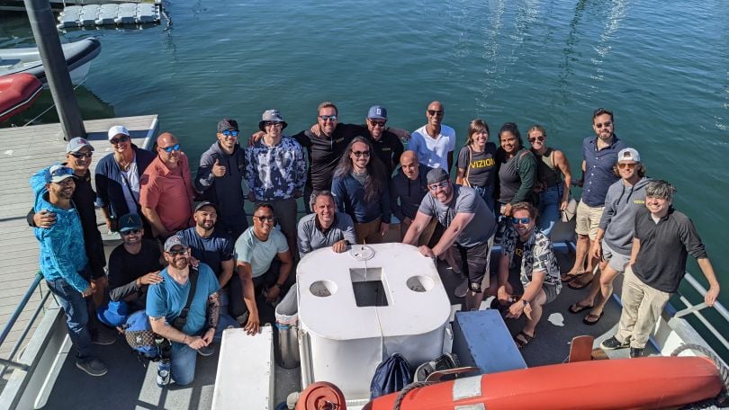 Vizion's team members posing for a photo on the back of a boat.