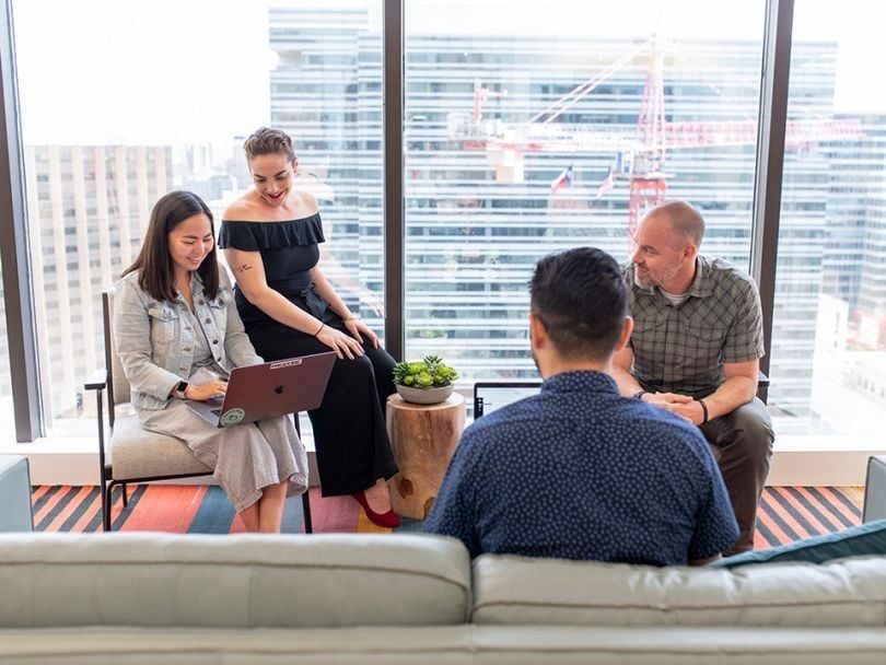 A group of Procore employees holding a meeting.