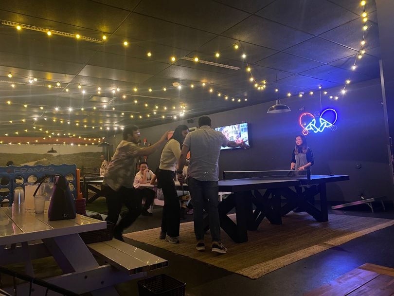 Pulse Analytics team members playing ping pong