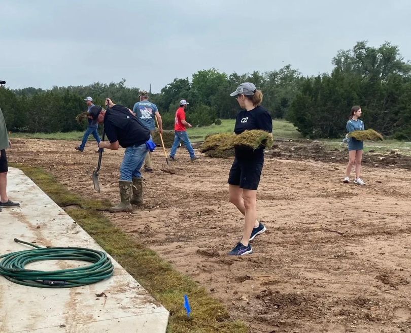 Q2 team members performing landscaping work as community volunteers.