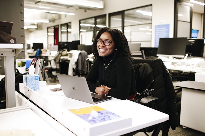 A Quartet Health employee poses for a photo in the office