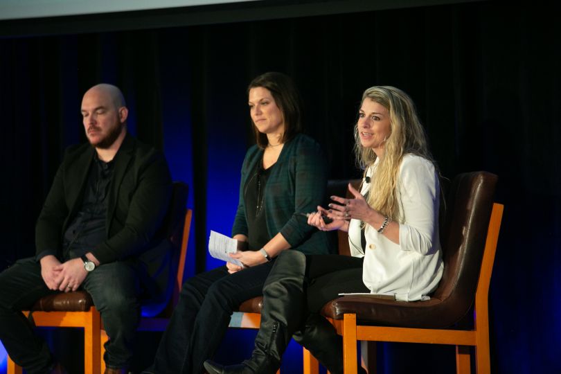 Candid photo of Rachel talking during a panel discussion onstage