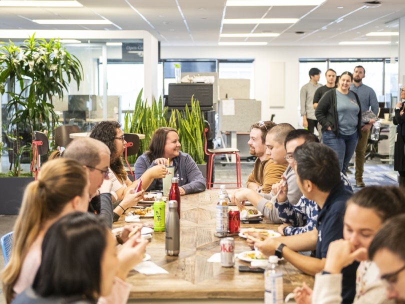 The Remitly team eating a meal together at the company's office