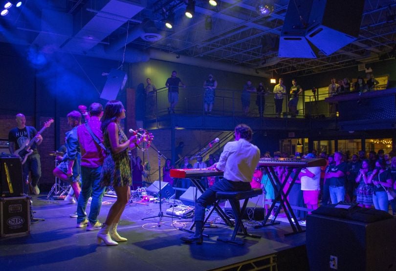 reverb colleagues performing music on stage at an event