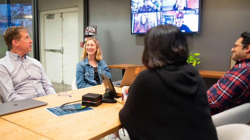 Reverb colleagues having a team huddle in the office