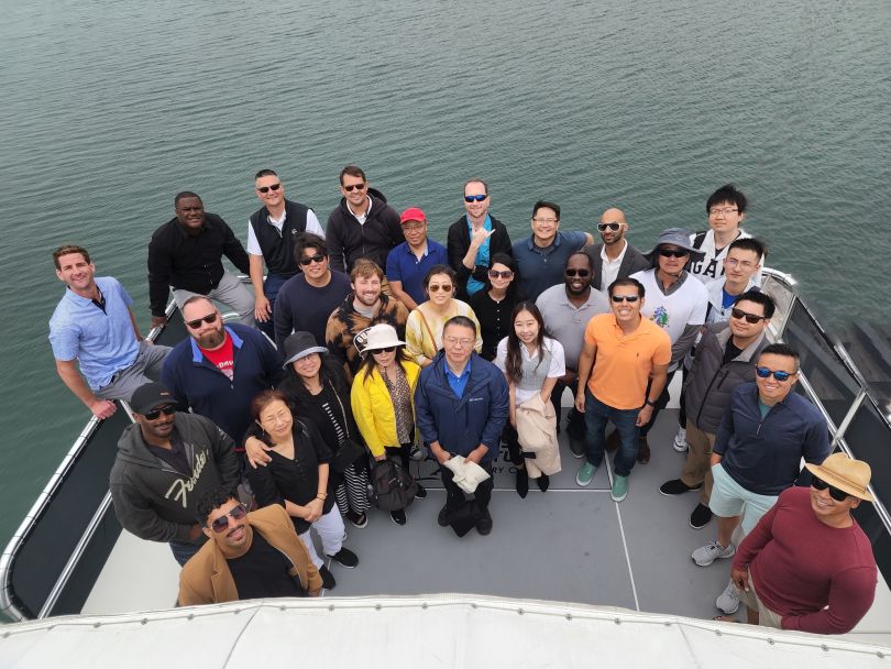 A group of SHEIN employees stand on a boat