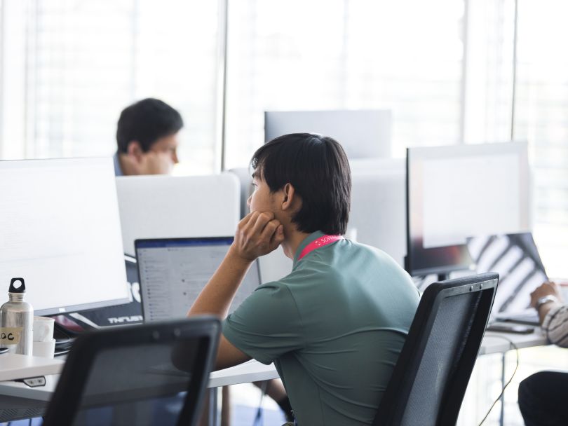 A SOPHiA GENETICS employee works at a desktop computer at the office.