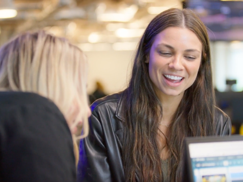 Brandi Knupp chatting with another team member in the SciPlay office.