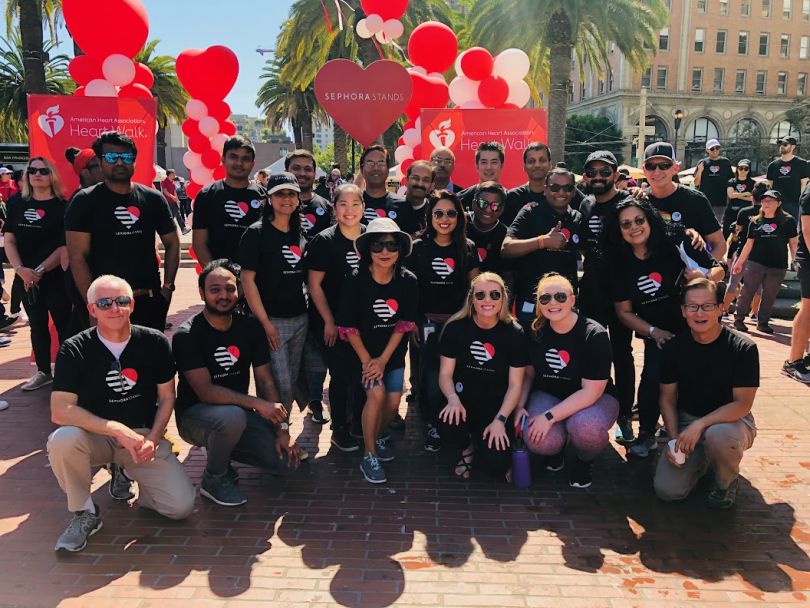 Sephora employees wear matching black shirts at an outdoors event