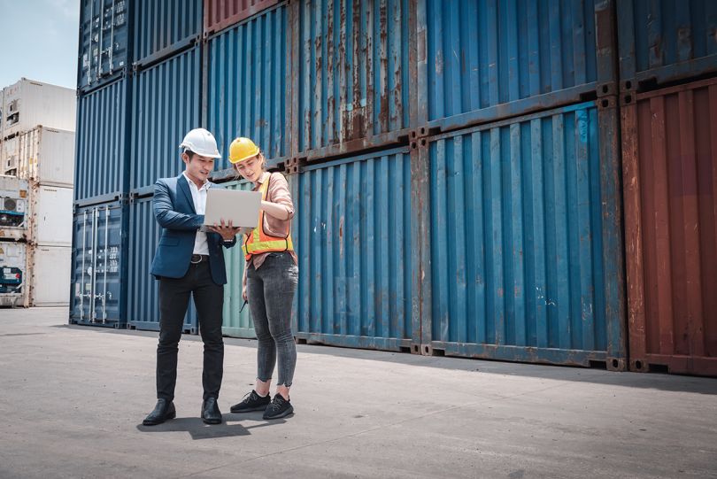 Transport engineers working together at port ship loading dock