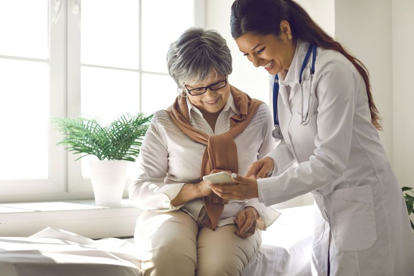 stock photo of doctor in white coat interacting with patient