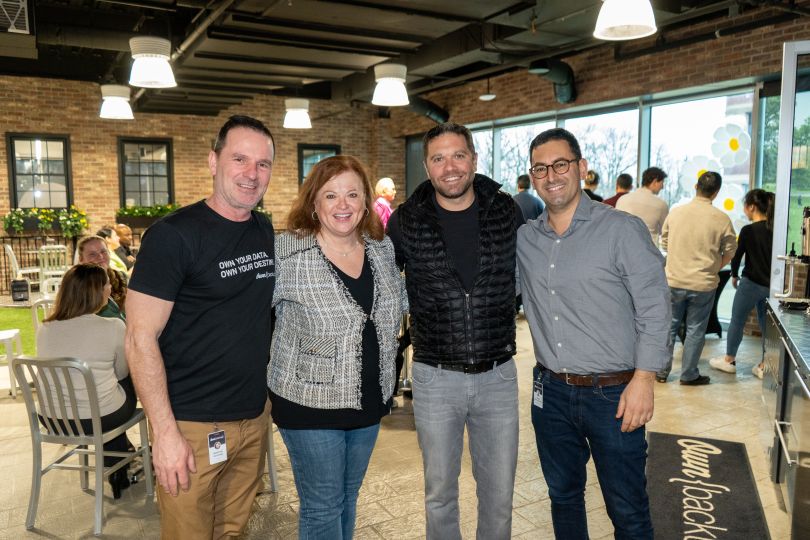 Photo of four OwnBackup team members in their office kitchen area