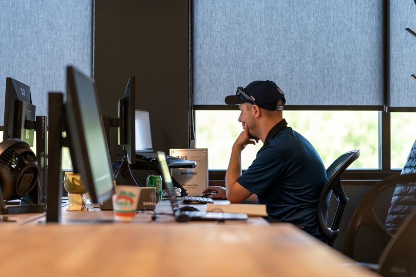 Swimlane team member working on a computer in the office